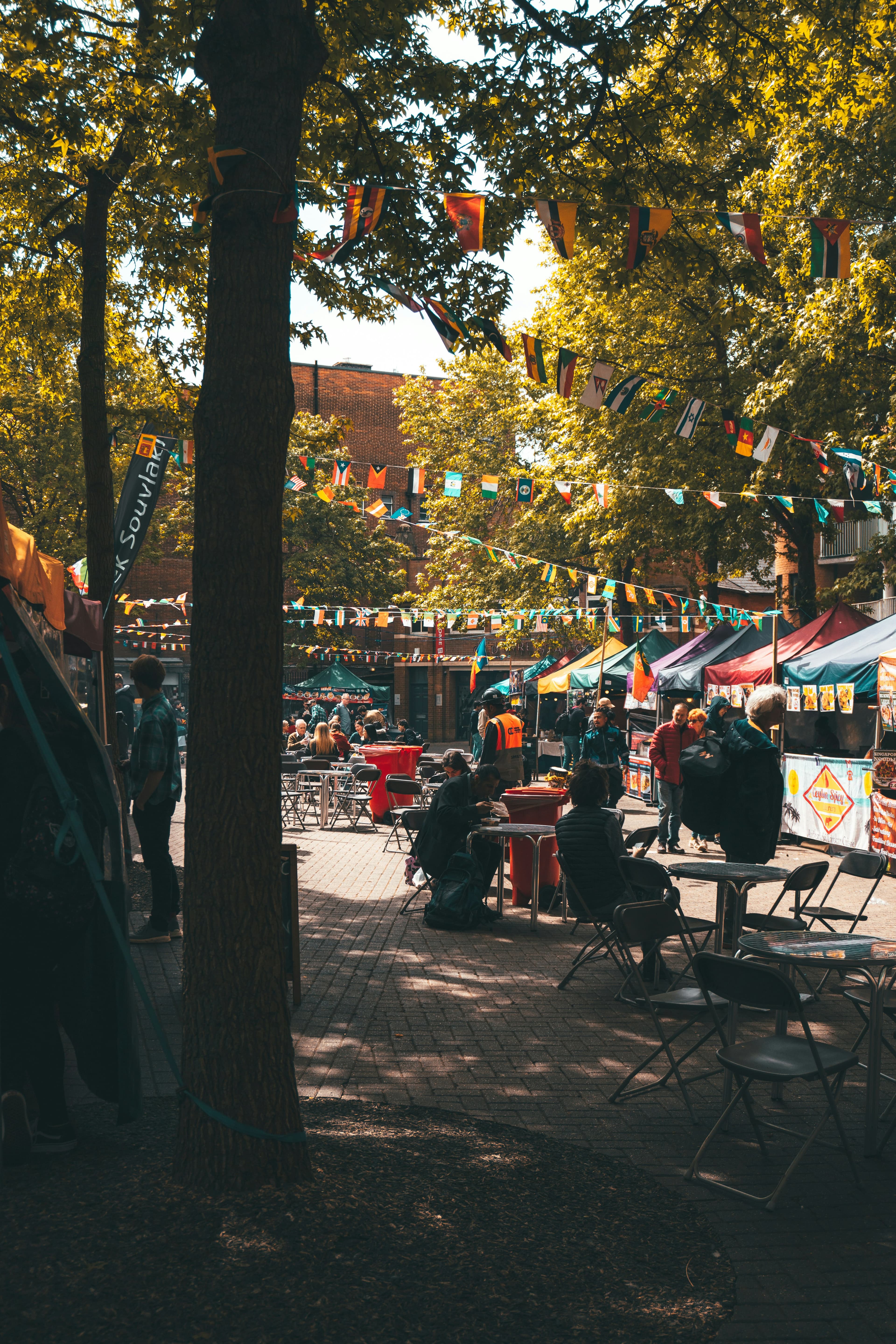 People sitting at tables at a food festival.